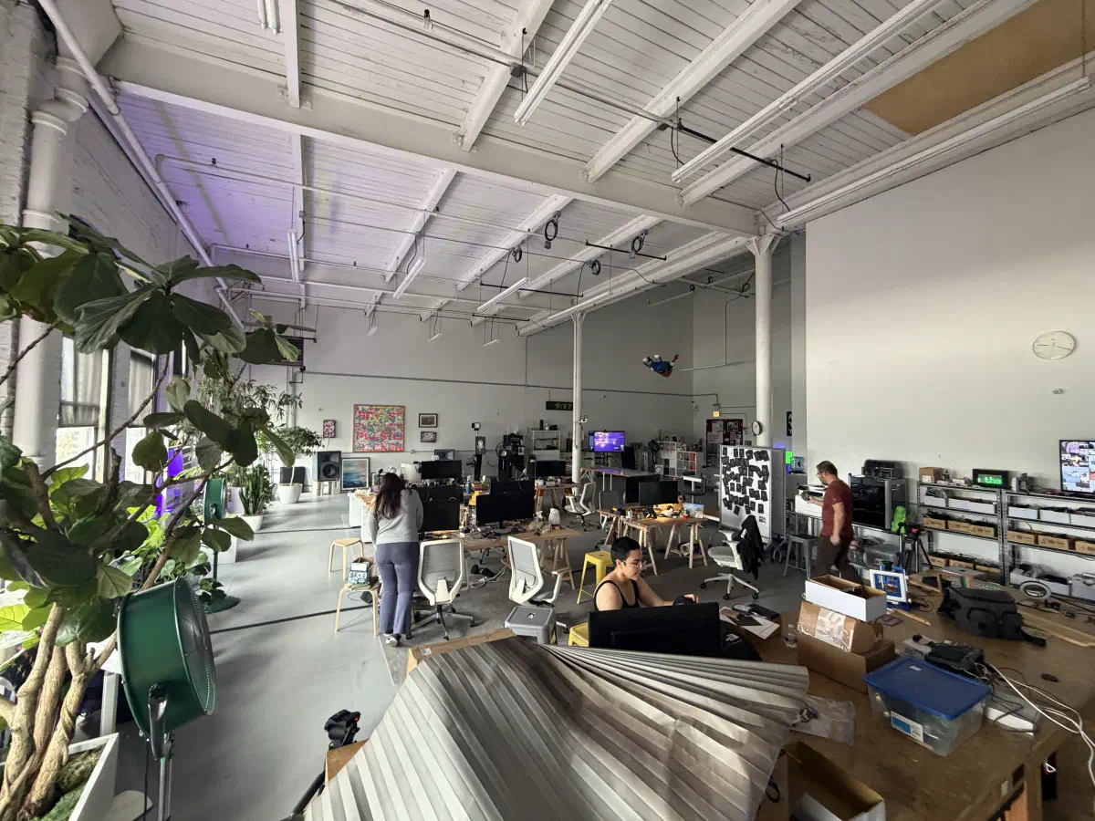 People working among plants, computers, and equipment in the 2389 Research office.