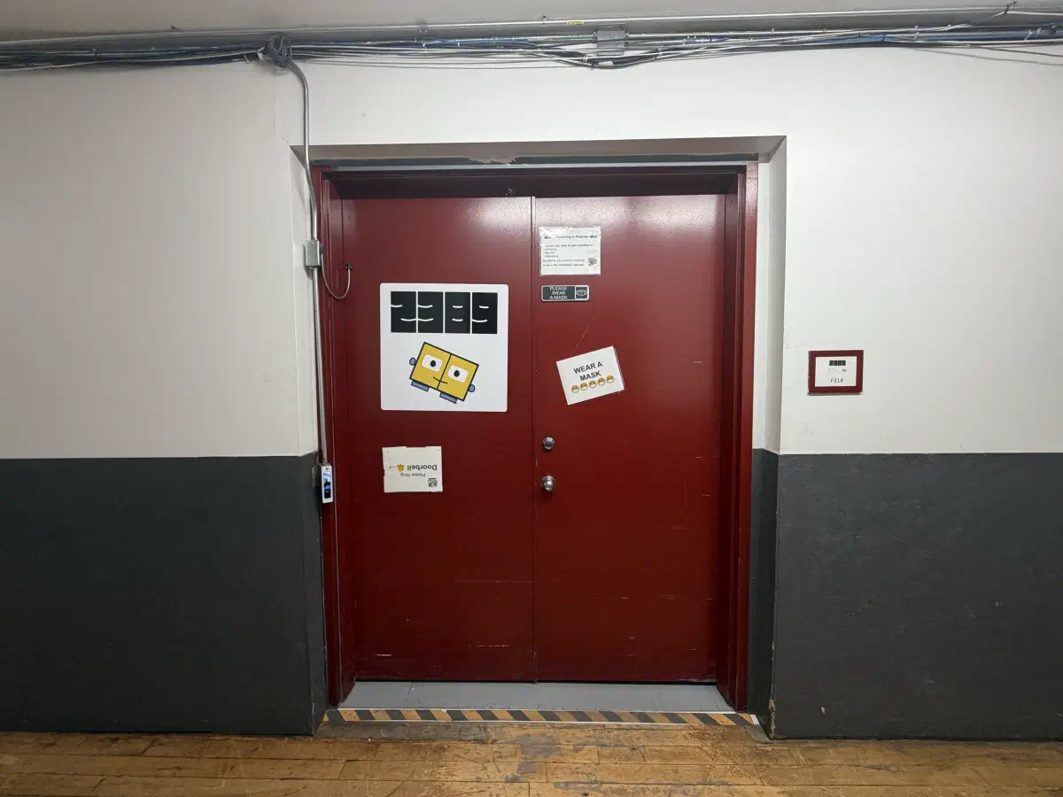 Pair of red double doors marked 2389 and F314 inside the building.
