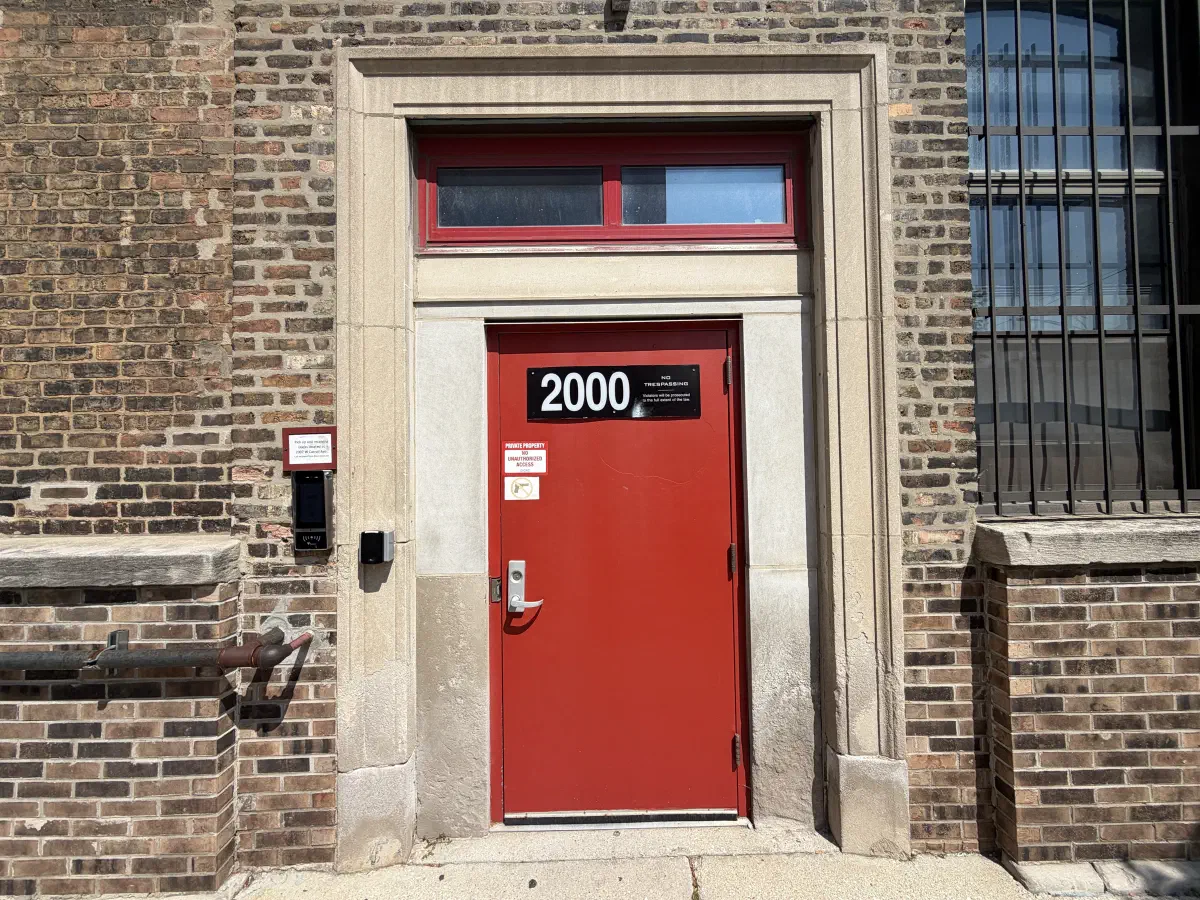 Red street door marked 2000 at the 2389 Research building.